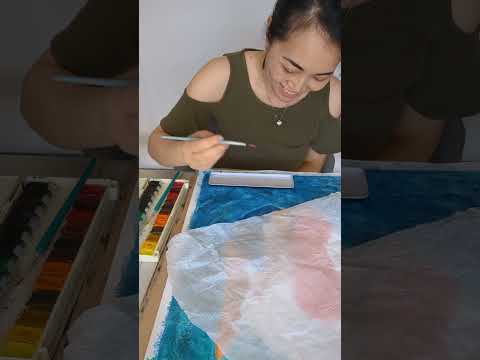 Hue the Artist process video of Taking Flight artwork in the making. Woman with long red hair diving from clouds into a blue ocean.