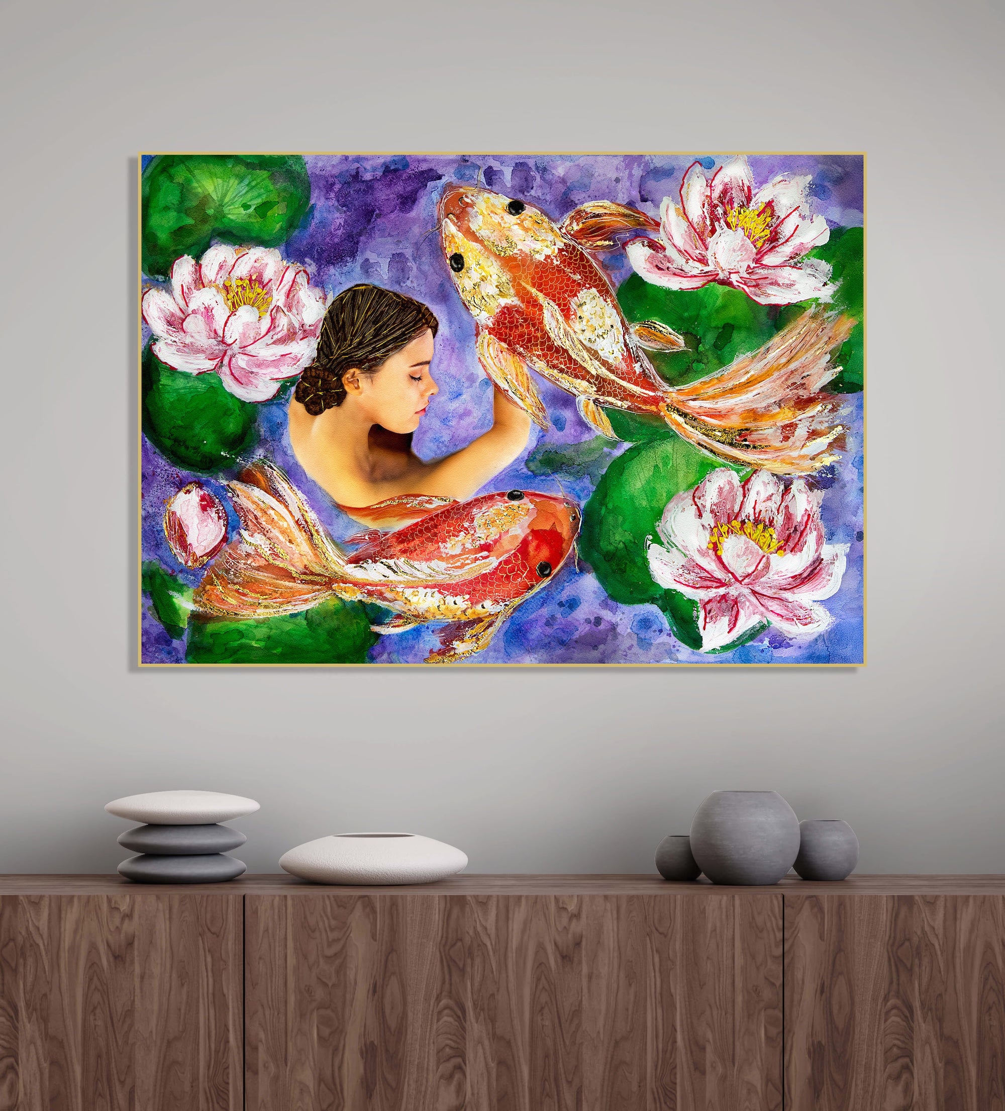 Room with zen stone decor  - three cement pots, and a stack of flat stones on top of each other. A framed figurative print in purple, green and oranges sits above it. 