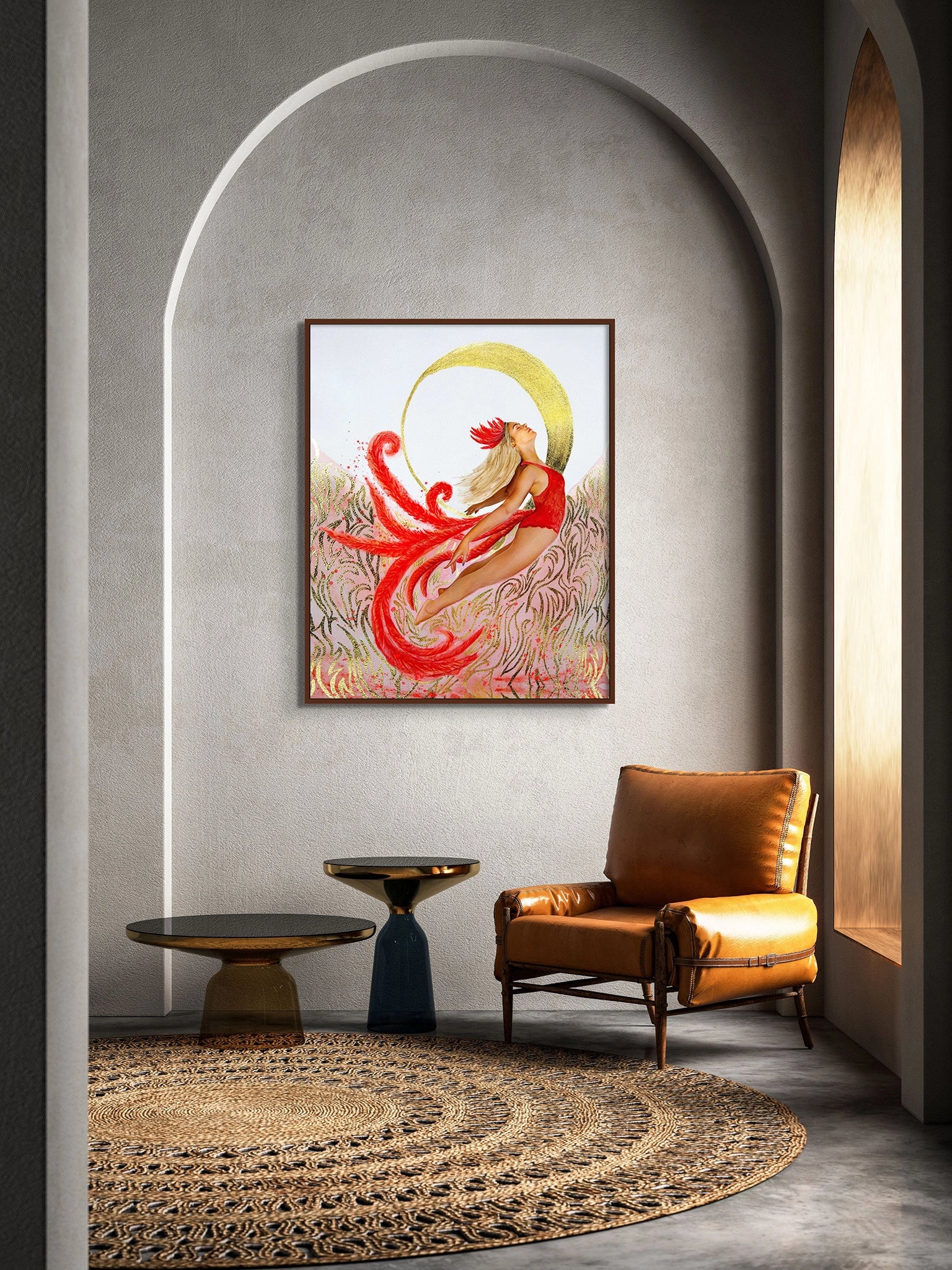 Large framed Hue the Artist art print of an empowered woman in red flying up to the moon hangs in an arched wall, with a caramel leather chair and two round tables and large straw rug.