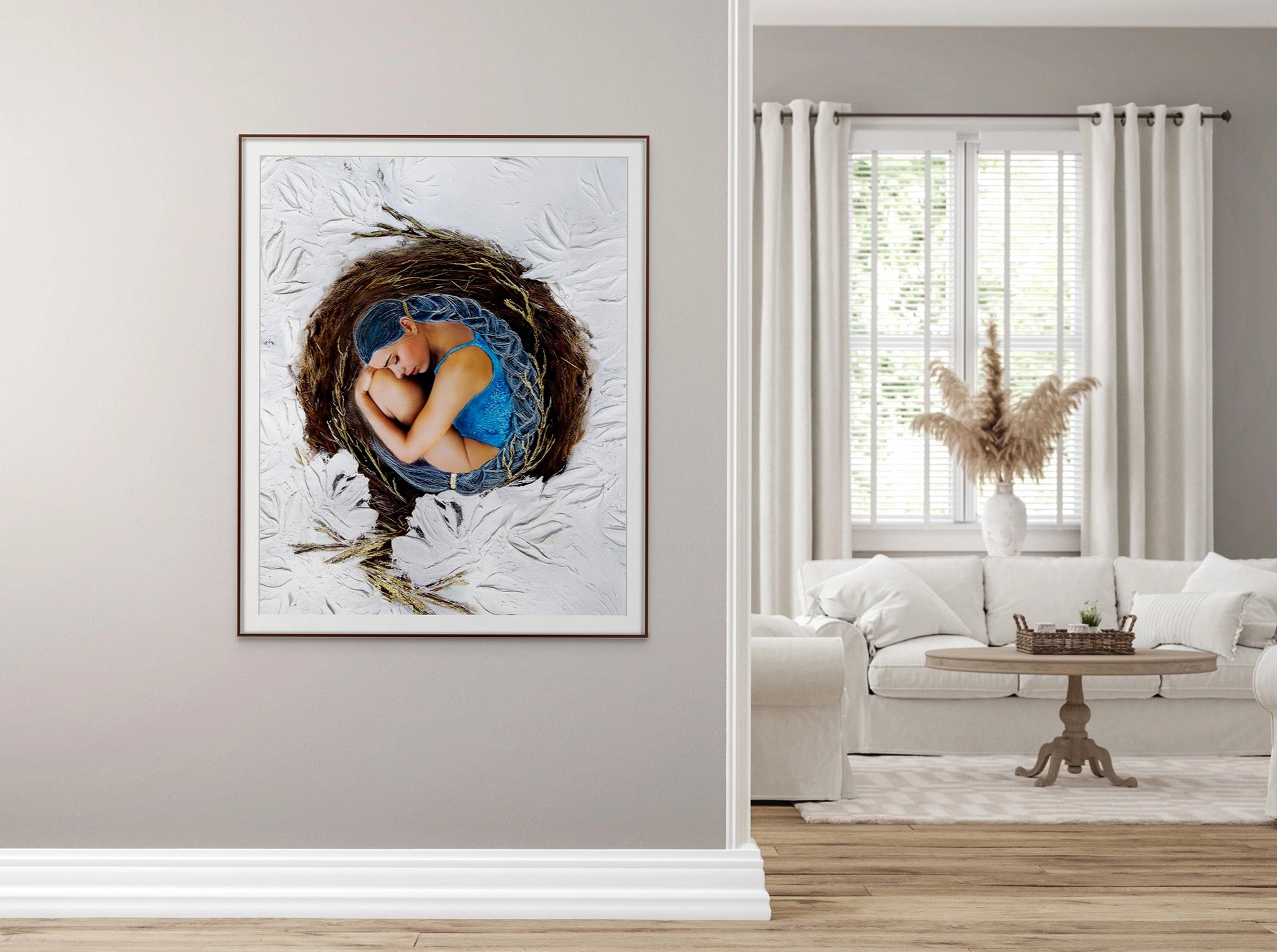 Large framed Hue the Artist wall print of a woman with blue hair curled inside a birds nest. It hangs on a wall outside a classic room with classy white decor.