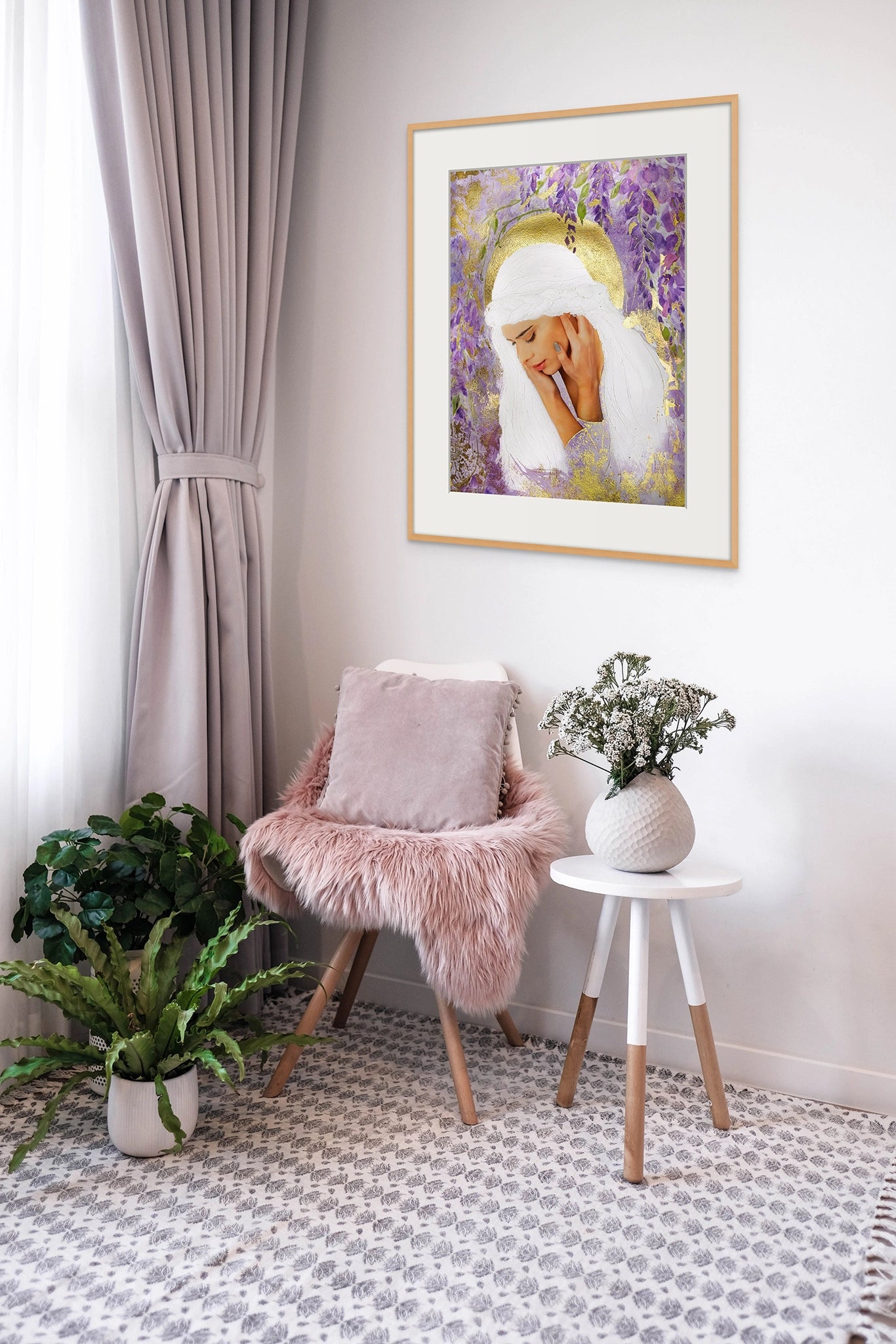 Framed Hue the Artist art print of a sad white haired woman, surrounded by purple wisteria and gold foil details hangs in a lilac room with pot plants, armchair, rug and curtains.